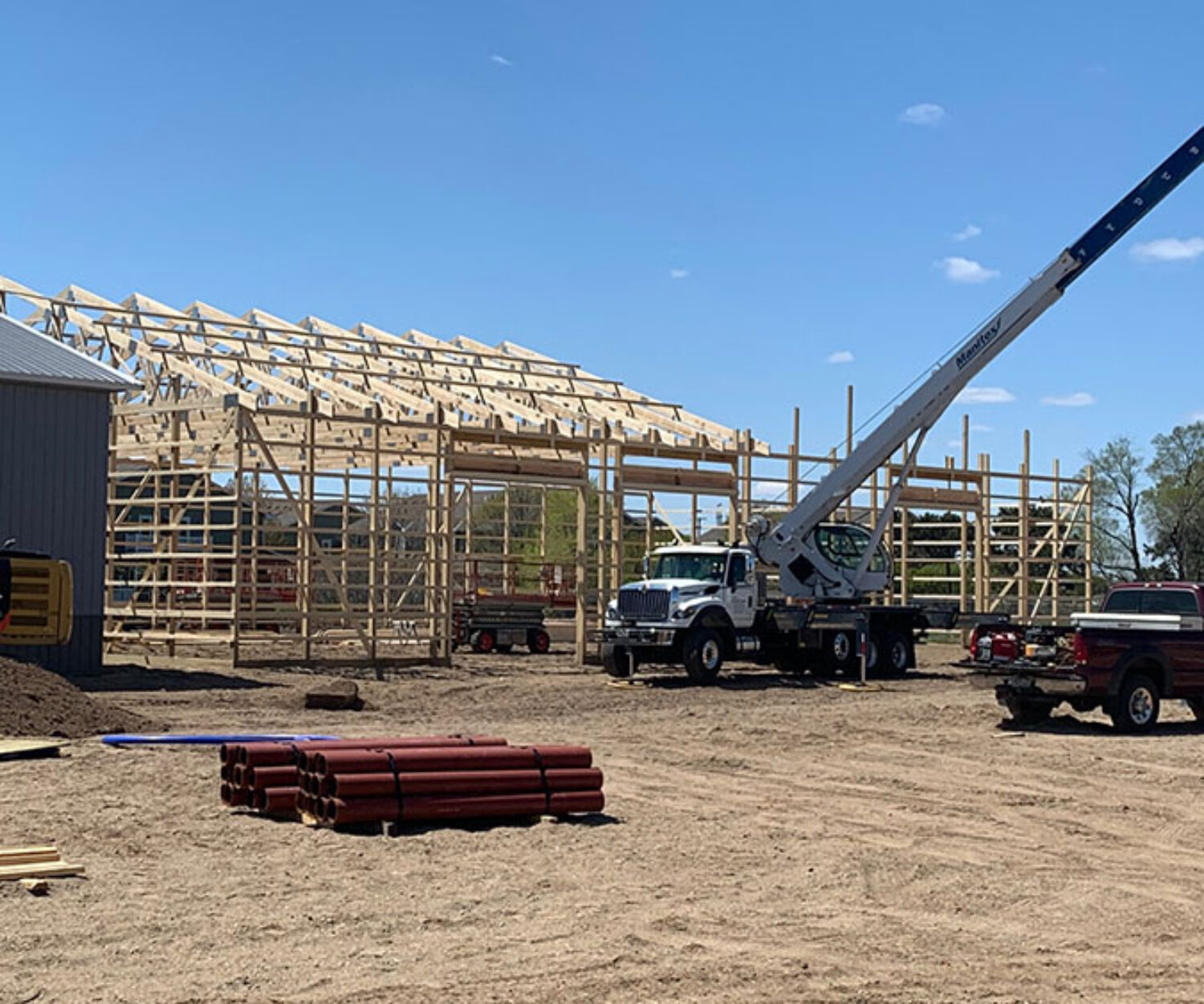 Truss setting by crane service for 60'x100' pole barn
