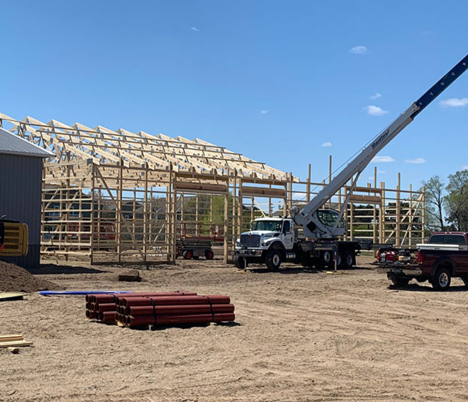 Truss setting by crane service for 60'x100' pole barn